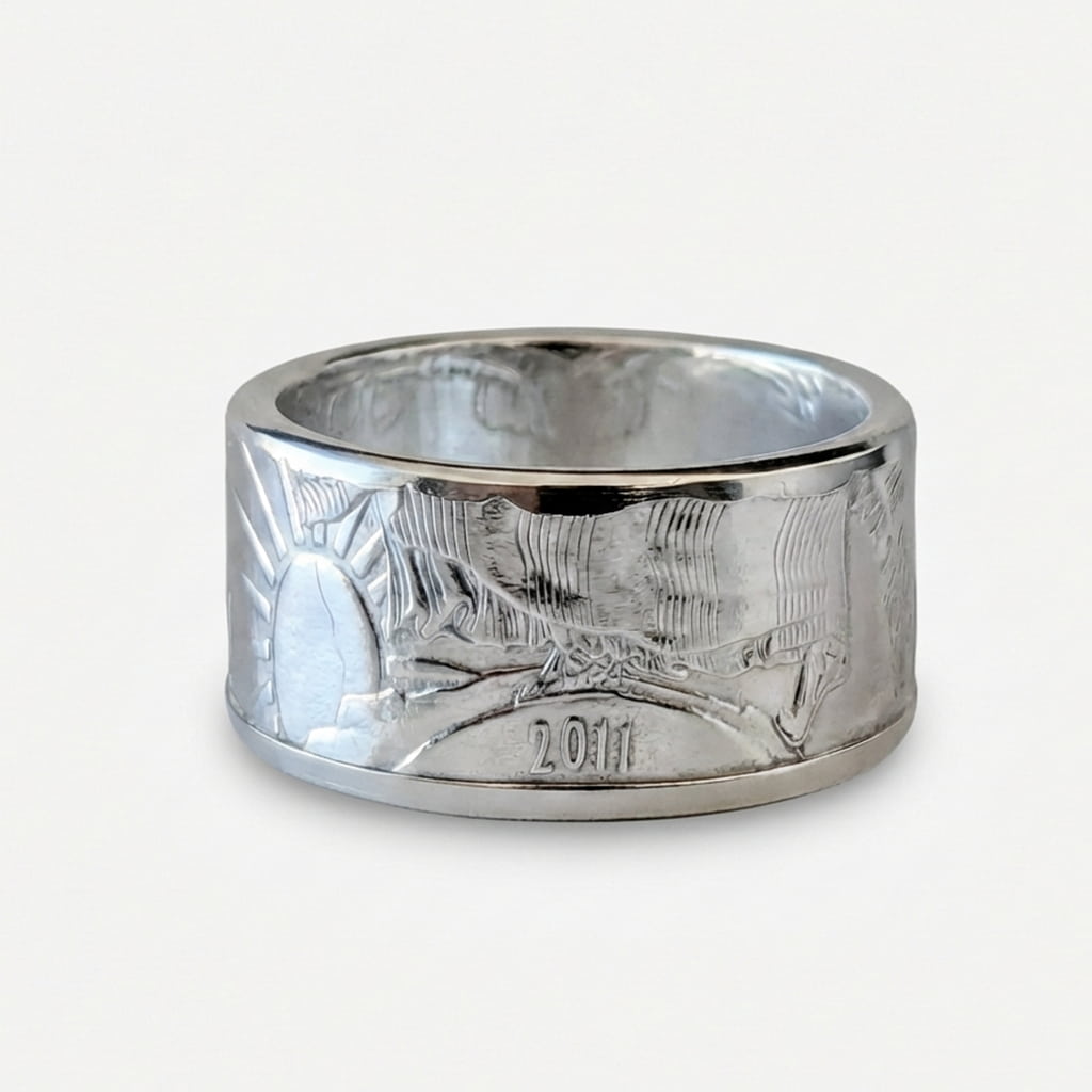 Polished American Silver Eagle coin ring laying flat with the date out.