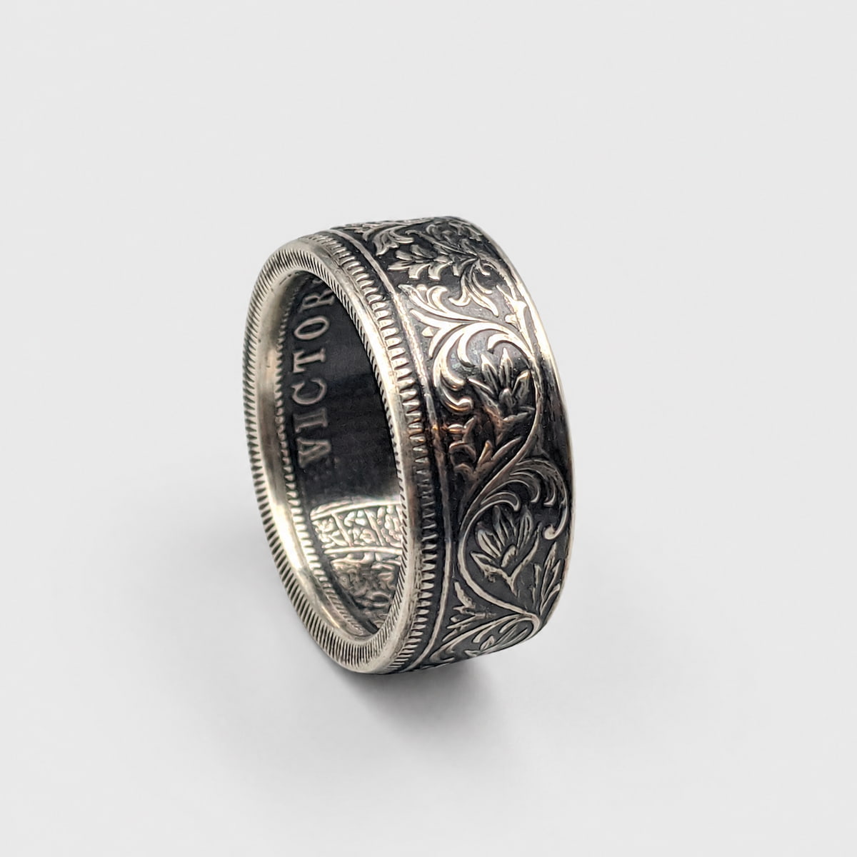 Indian 1 rupee silver coin ring standing on edge with a patina finish from Silver State Foundry