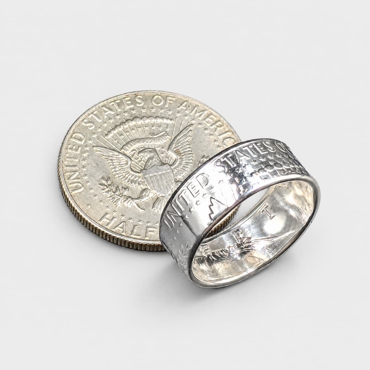 JFK half dollar coin ring and coin with a polished finish from Silver State Foundry