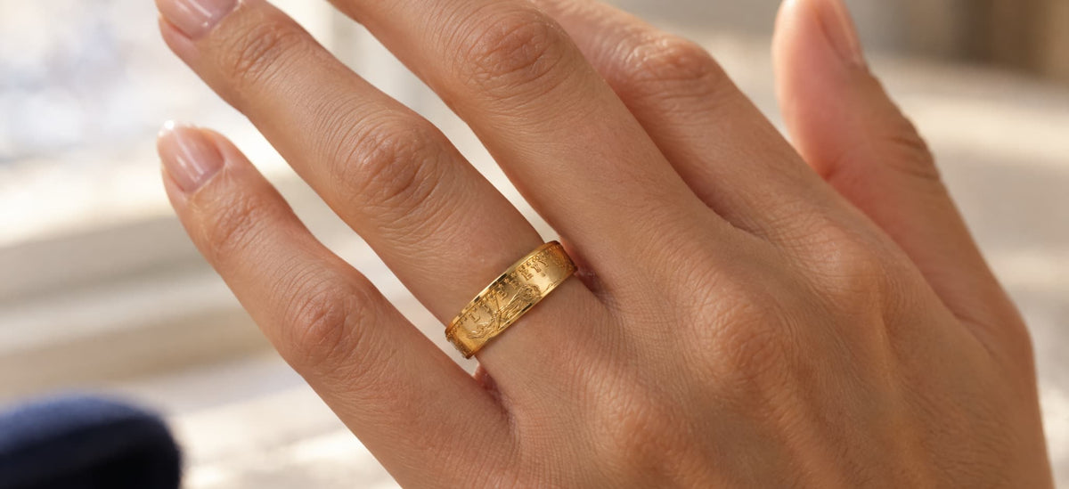 Woman's hand wearing an American Gold Eagle coin ring