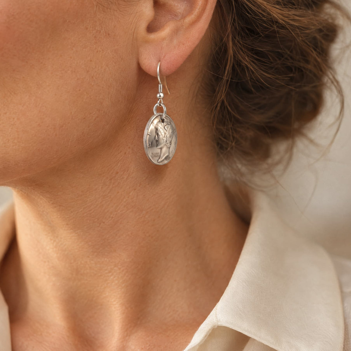 Woman wearing a Mercury Dime earring