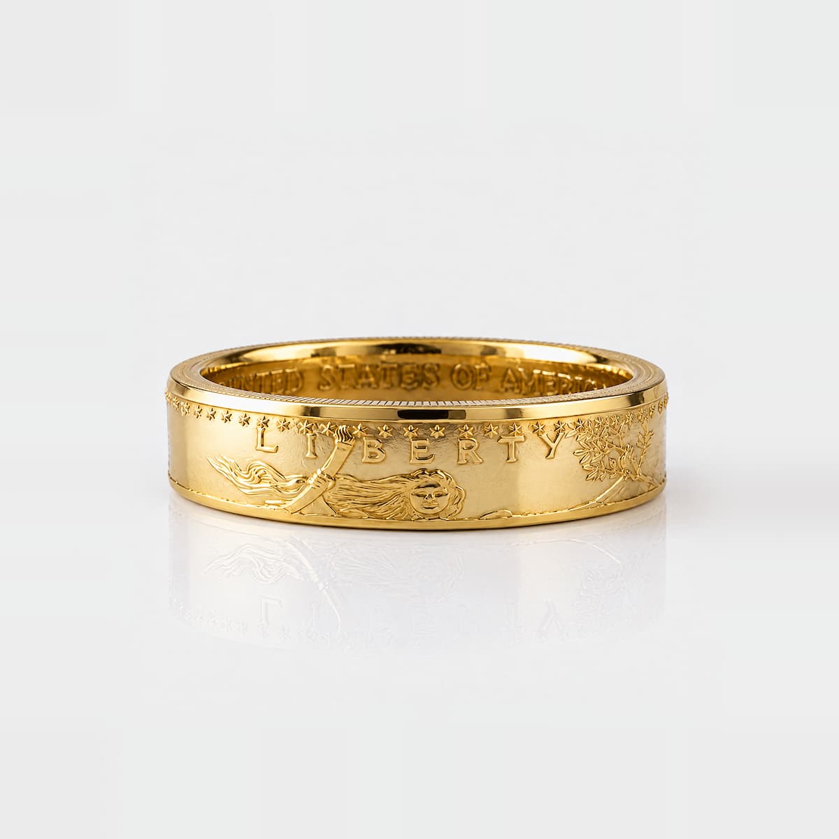 American Gold Eagle coin ring made from a quarter ounce gold coin, laying flat and showing Lady Liberty's face.