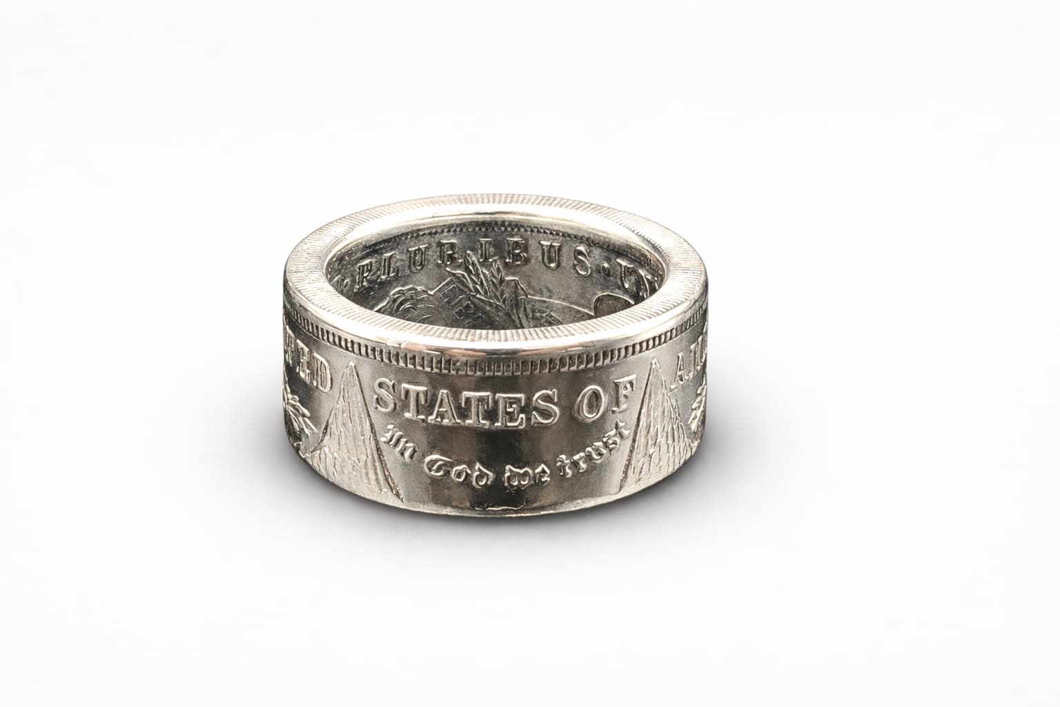 A polished Morgan Silver Dollar coin ring centered on a white background