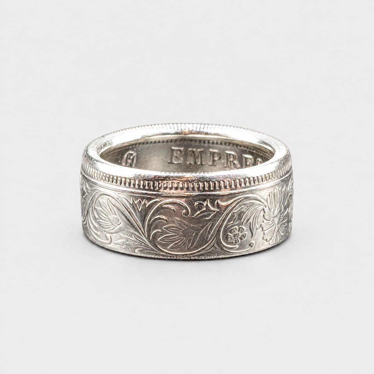 Indian 1 rupee silver coin ring laying flat with a polished finish from Silver State Foundry