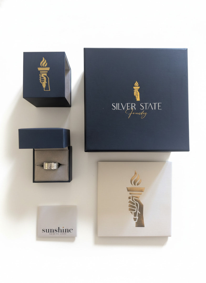 Silver State Jewelry packaging with a ring and 'sunshine' card on a white background