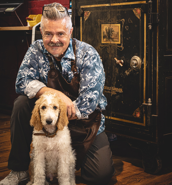 Terry Ladd and Donovan in front of an antique safe