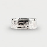 Polished Walking Liberty half dollar coin ring laying flat on a white background.