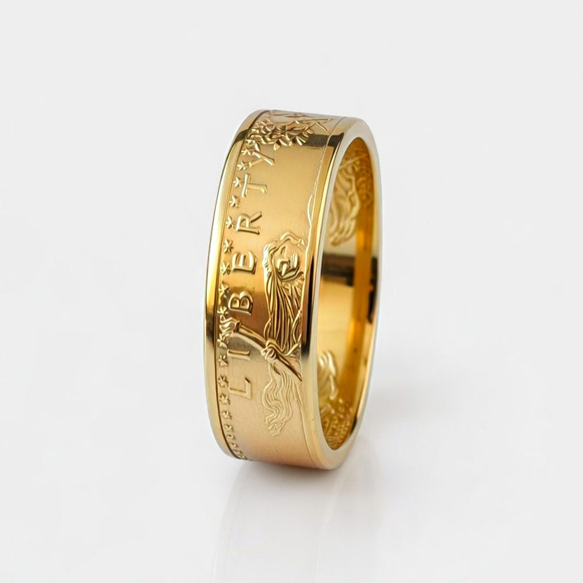 Gold coin ring forged from a half ounce American Gold Eagle coin, standing on edge and showing Lady Liberty on a white background.