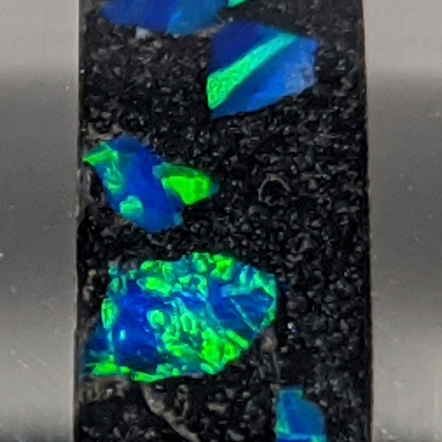 Detail of cremation ash coin ring inlay using azure blue opal