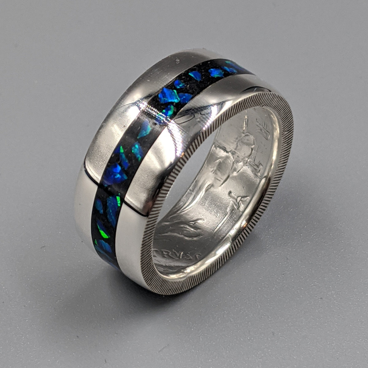 azure blue opal flashing blue and green in a cremation ash coin ring