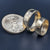 A pair of gold eagle wedding bands with a gold eagle coin