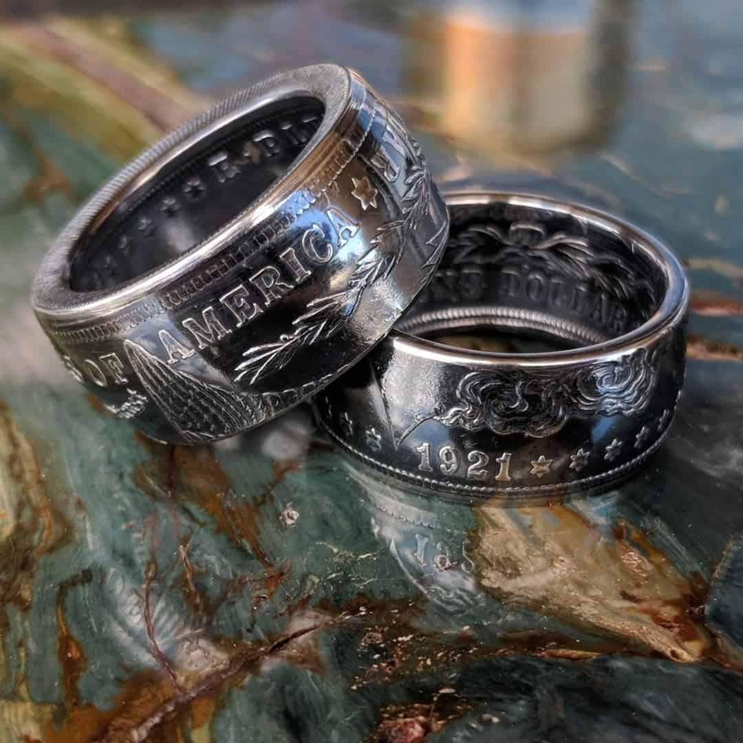 A pair of Morgan Silver Dollar coin rings with a deep patina finish