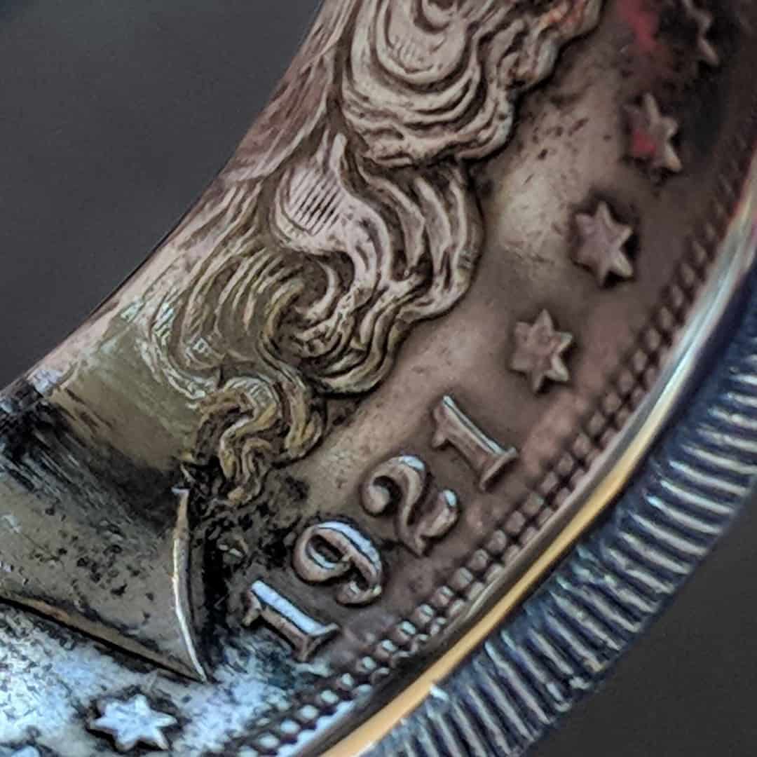 Date detail on a 1921 Morgan Silver Dollar coin ring.