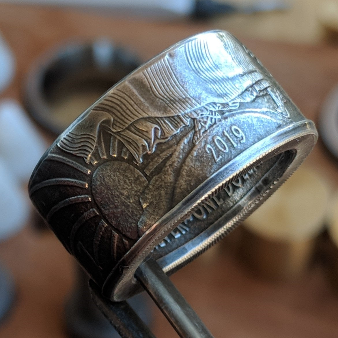 Silver Eagle coin ring with the year showing on the outside of the band.