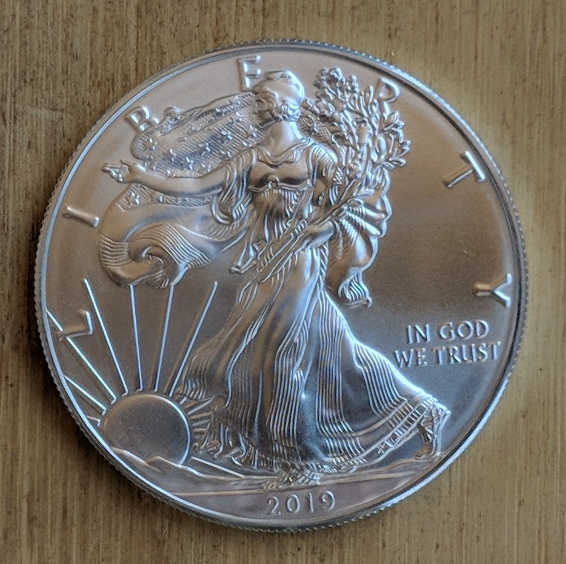 Silver Eagle bullion coin with Lady Liberty striding toward the rising sun. 