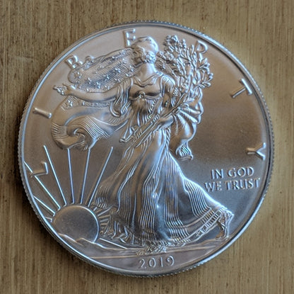 Silver Eagle bullion coin with Lady Liberty striding toward the rising sun. 